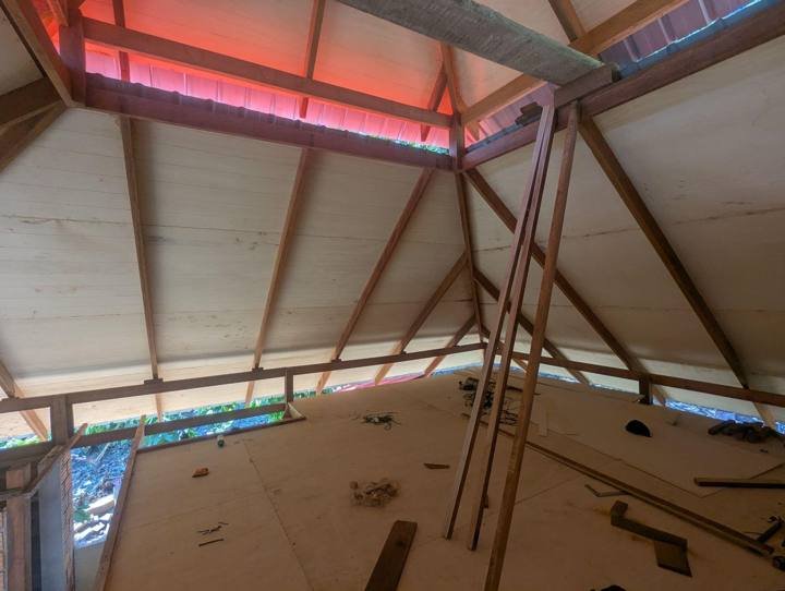 El cielo raso instalándose arriba, bajo las ventilaciones del techo.